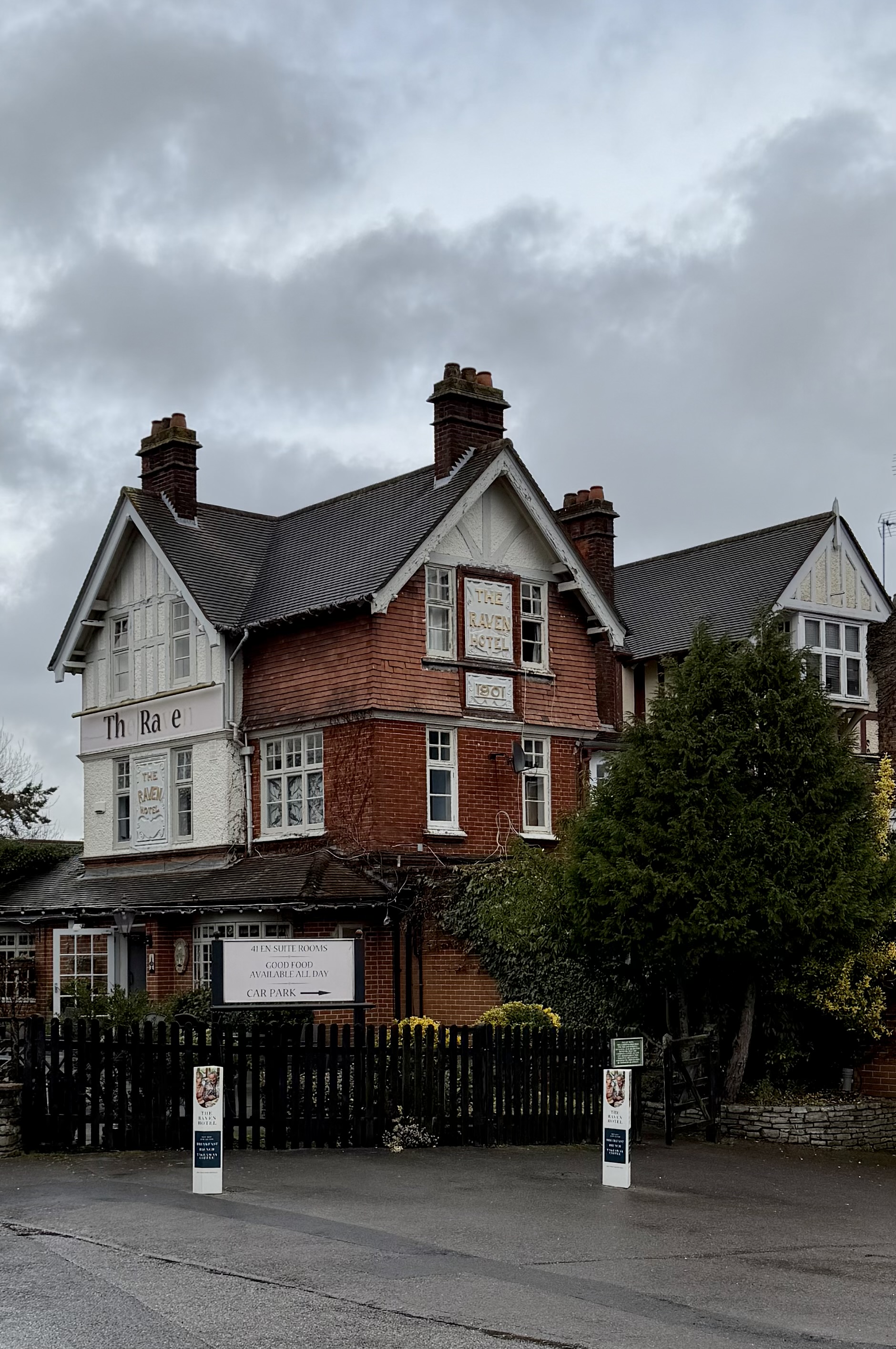 The Raven Hotel, Hook - Tudor Revival facade with half-timbered gables on Station Road beside Hook railway station
